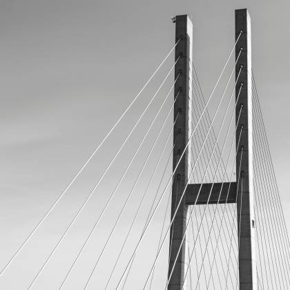 Monochrome Image Of A Modern Suspension Bridge Showcasing Its Architectural Elegance.