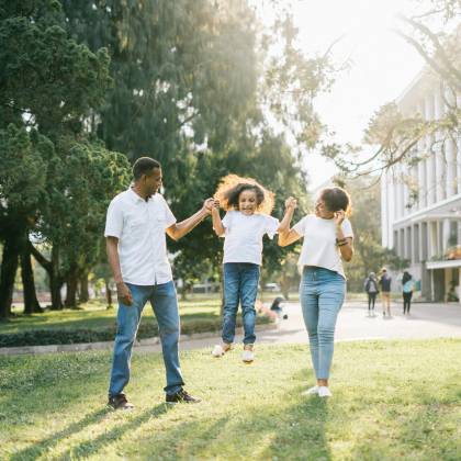 Joyful Family Enjoying A Playful Day At The Park, Embracing Love And Togetherness Under The Summer Sun.