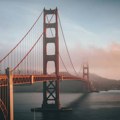 Golden Gate Bridge Shrouded In Fog During Sunset, San Francisco.