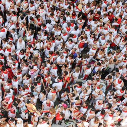 High Angle View Of A Bustling Festival Crowd Dressed In White And Red Attire.