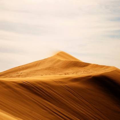 Captivating View Of Sand Dunes Stretching Under A Serene Blue Sky In Caleu Caleu, Argentina.