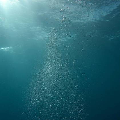 Peaceful Underwater Scene With Sunlight And Streaming Bubbles In The Ocean.