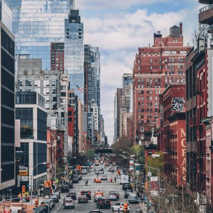 Bustling Street Scene In NYC With Iconic Skyscrapers And Busy Traffic.