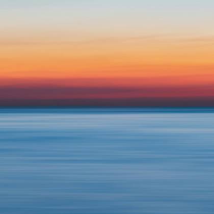 A Colorful Sunset Over A Calm Ocean, Perfect For Vibrant Backgrounds.