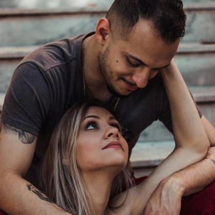 A Loving Couple Shares An Intimate Moment On A Staircase, Conveying Romance And Connection.