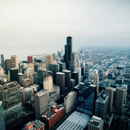 Aerial View Of Chicago's Skyline Featuring The Iconic Willis Tower At Dusk.