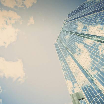A Stunning Skyscraper In London, Ontario Reflecting Clouds On Its Glass Facade.
