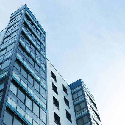 Low Angle View Of A Modern Glass Skyscraper Against A Clear Sky In Poole, UK.