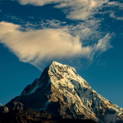 Stunning Snow Capped Mountain Peak Under A Vibrant Sky, Perfect For Nature Lovers.