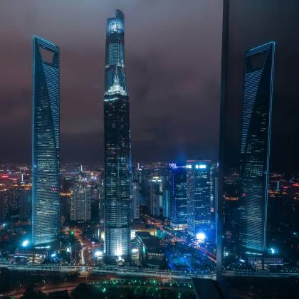 Breathtaking View Of Shanghai's Illuminated Skyscrapers At Night, Showcasing Modern Architecture.