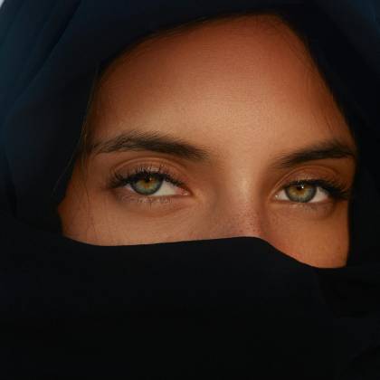 Close Up Portrait Of A Woman With Heterochromia Wearing A Hijab Highlighting Her Unique Eyes.