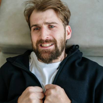 A Distressed Man Lying Down, Expressing Emotion In A Therapy Setting.