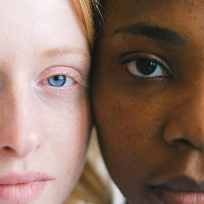 Intimate Close Up Of Two Women Of Different Ethnicities Showcasing Diversity.