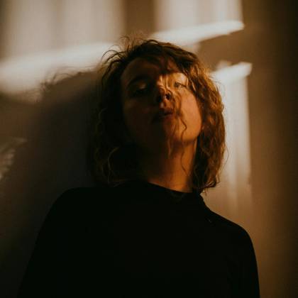 Artistic Portrait Of A Woman In Shadows, Creating A Mysterious Atmosphere Indoors.