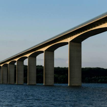 A Striking Architectural Bridge Crossing Over Tranquil Waters, Capturing The Essence Of Modern Infrastructure.