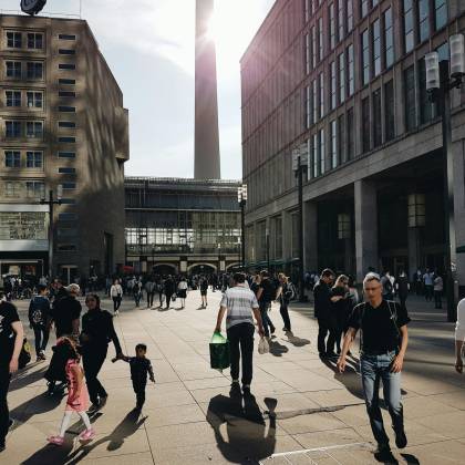 A Busy Shopping Street In Berlin With Pedestrians Enjoying A Sunny Day In The City Center.