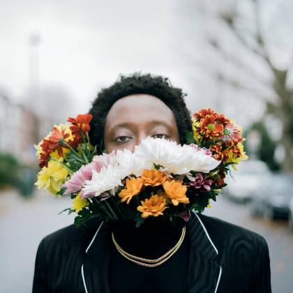 Creative Portrait Of A Man With Floral Arrangement Outdoors, Blending Art And Nature.