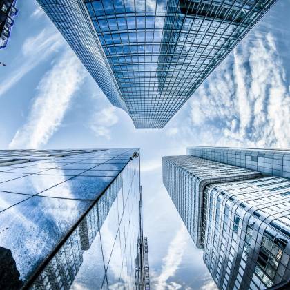 Low Angle Shot Of Modern Skyscrapers In Frankfurt, Showing Reflections And Sky.