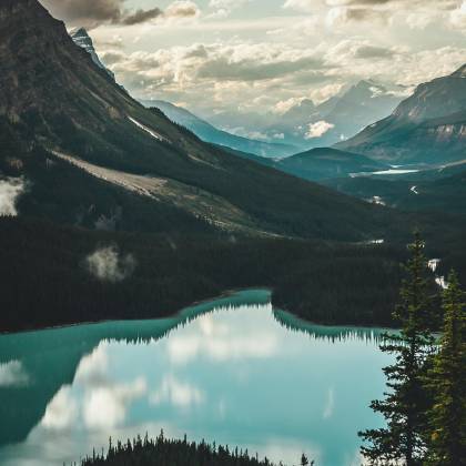 Stunning View Of A Tranquil Lake Surrounded By Towering Mountains In The Canadian Rockies.