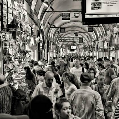A Crowded Scene Capturing The Vibrant Commerce Of Istanbul's Famous Grand Bazaar, Showcasing The Lively Atmosphere And Diverse Society.