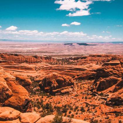 Beautiful View Of A Red Rock Desert Canyon Under A Clear Blue Sky, Showcasing Natural Geological Formations.
