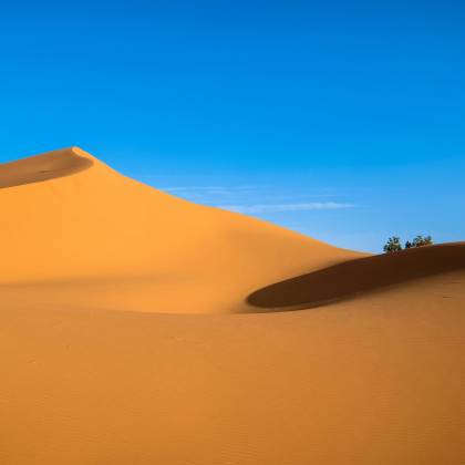 Stunning Golden Sand Dunes With Clear Blue Sky At Ksar Tanamouste, Morocco.